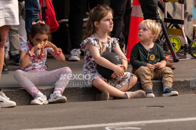 Children sitting in the gutter watching