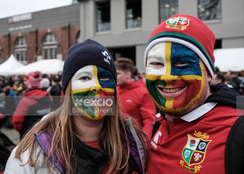 Couple face painted with British and Irish lions rugby team colours at a sporting event
