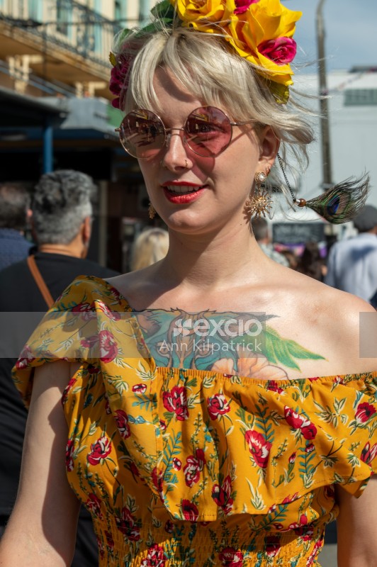 Woman with chest tattoo and sunglasses