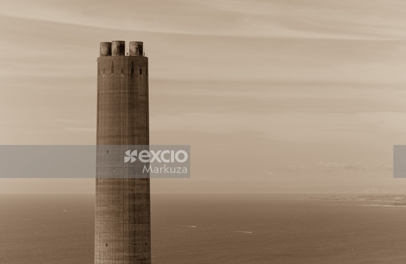Power station tower and ocean sepia