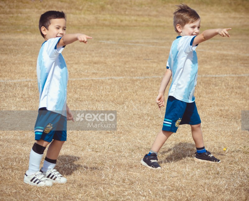 Two boys in Argentina team kit pointing fingers - Little Dribblers