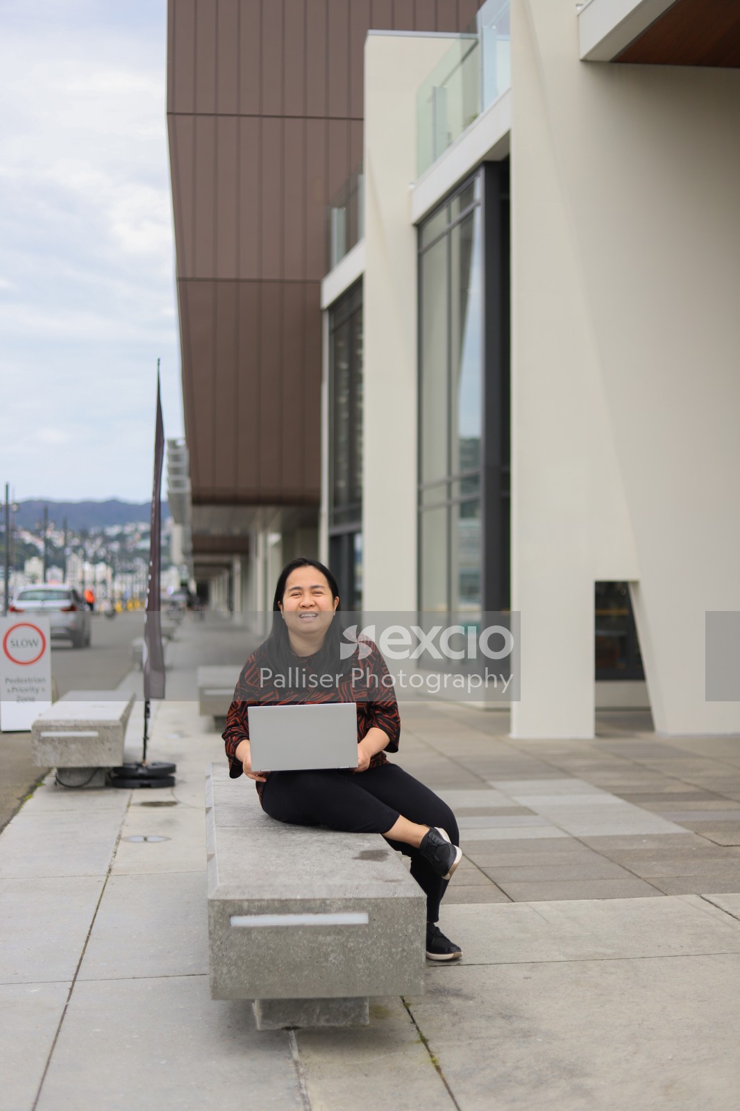 Female sitting with a laptop outdoor