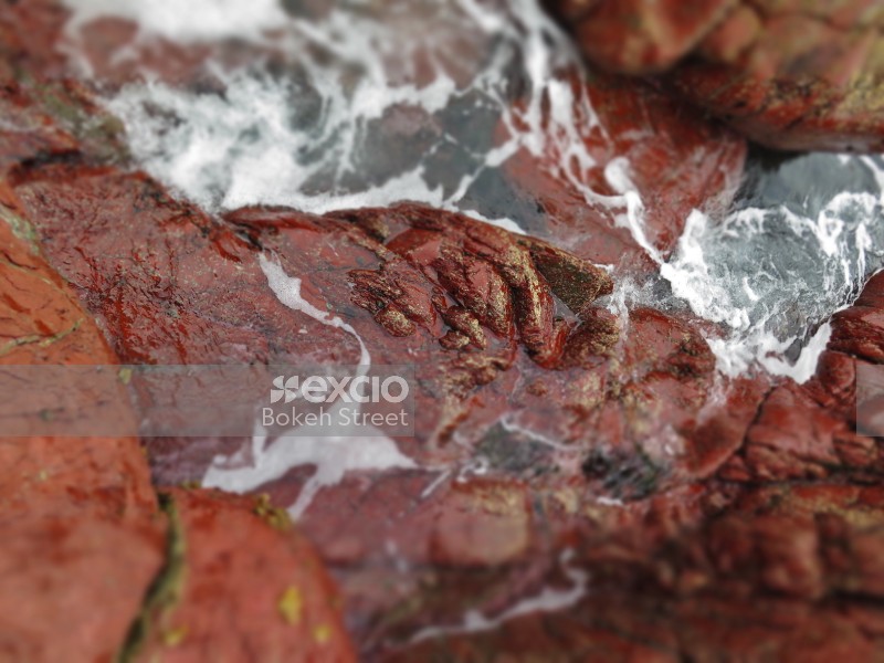 Red rocks and sea water foam bokeh