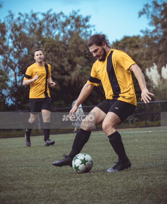 Player dribbling in a football match - Sports Zone sunday league