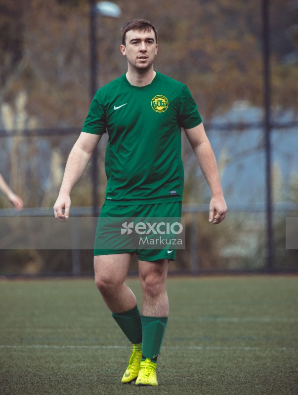 Guy in green Nike kit and neon yellow cleats - Sports Zone sunday league