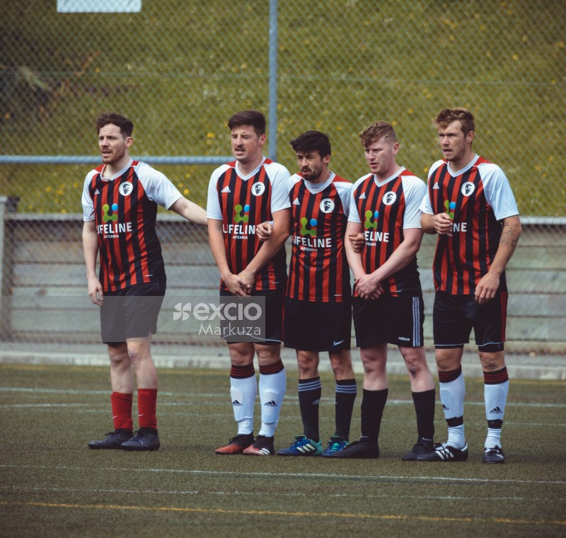 Super Paddys FC players stand in a line - Sports Zone sunday league