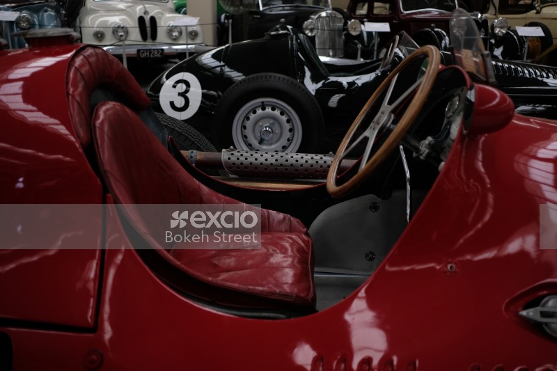 Classic red and black race cars at museum