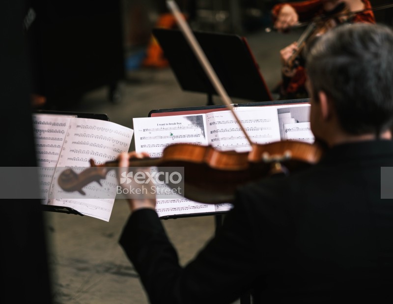 Violinists performing from score sheets