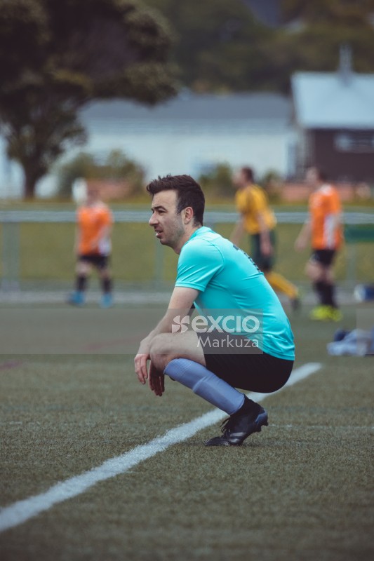 Player squatting on the sidelines - Sports Zone sunday league