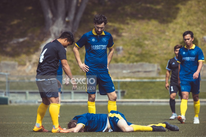 Injured player laying on the field - Sports Zone sunday league