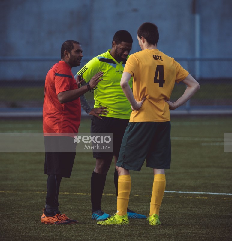 Referee resolving an argument between two opponents - Sports Zone sunday league