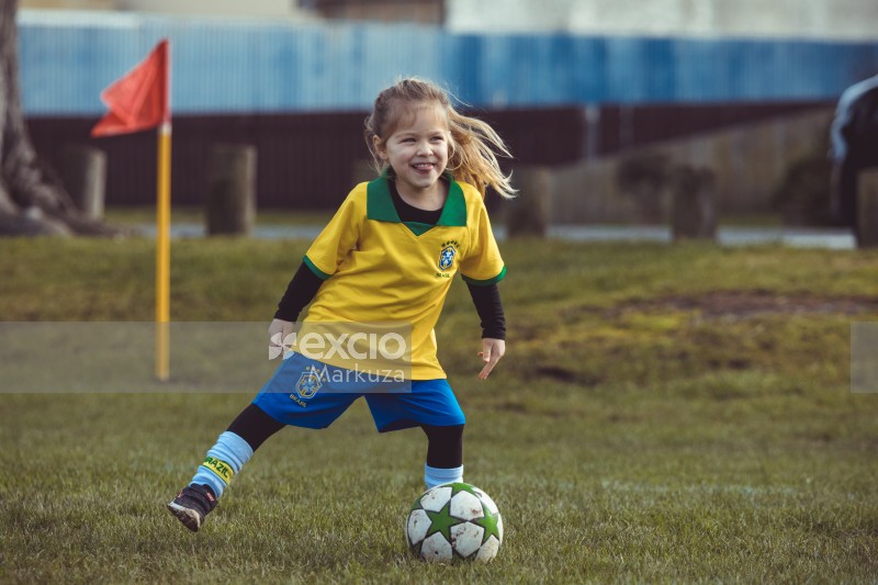 Girl in yellow shirt at Little Dribblers soccer match