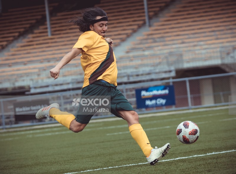 Player with long hair kicking football - Sports Zone sunday league