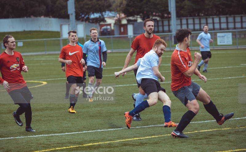 Football player in light blue shirt kicks football - Sports Zone sunday league