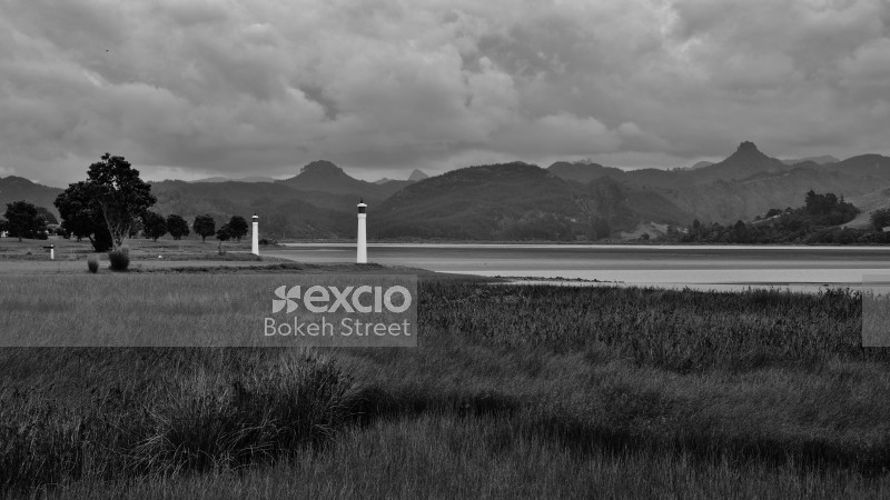 Hilly landscape and small light towers black and white
