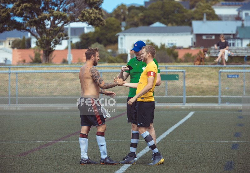 Shirtless player shakes hand at a football match - Sports Zone sunday league