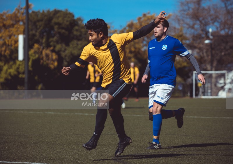 Player in a yellow Nike jersey kicks football - Sports Zone sunday league