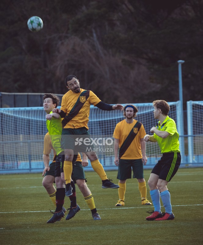Player with a goatee beard hits a header - Sports Zone sunday league