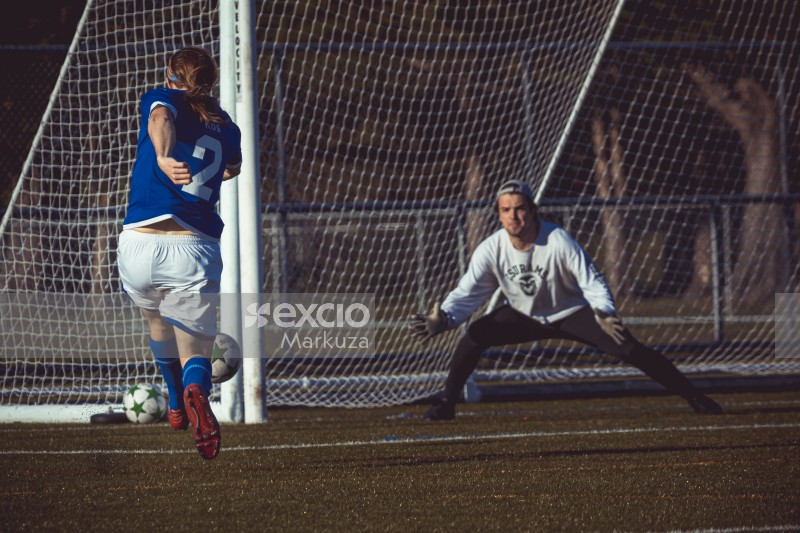 Frother FC player hitting a shot and goalkeeper trying to stop it - Sports Zone sunday league