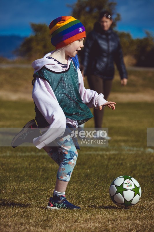 Girl kicking football at Little Dribblers football contest