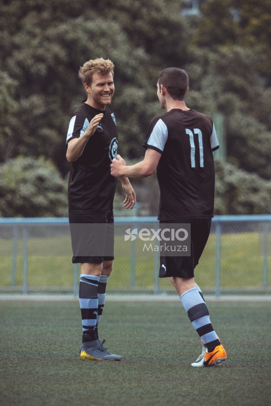 Two teammates shake hand Puma - Sports Zone sunday league