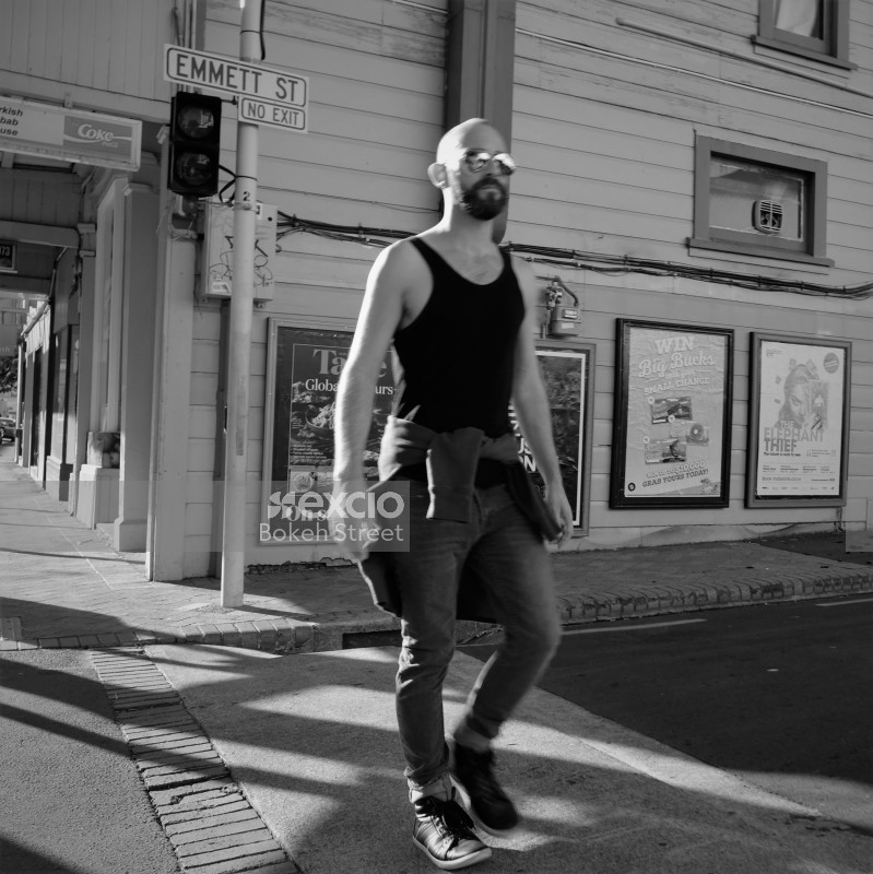 Bald guy in a tank top on the street in Newtown black and white