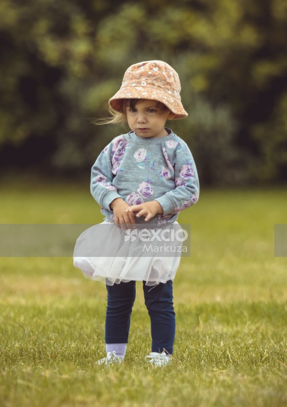 Girl wearing floral hat sweater skirt and pants - Little Dribblers
