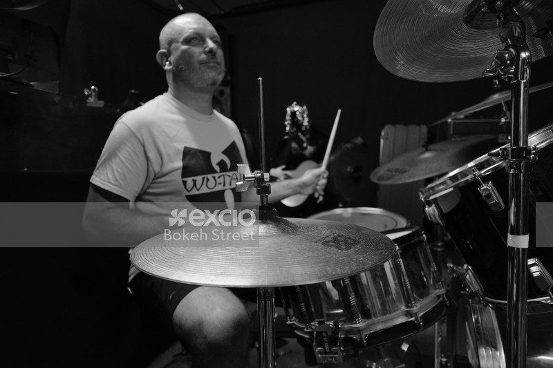 Drummer playing drums for band "Vietnam" monochrome