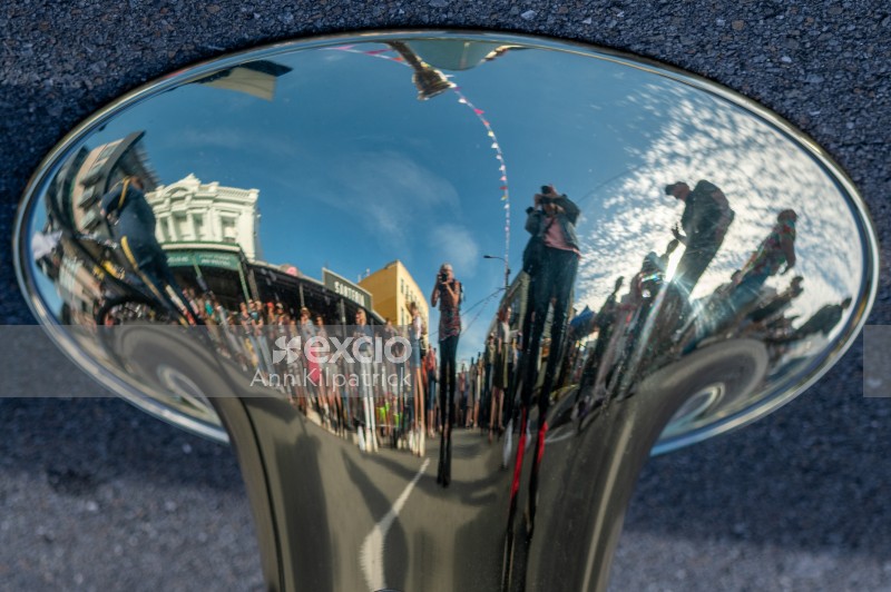 Crowd reflected in musical instrument