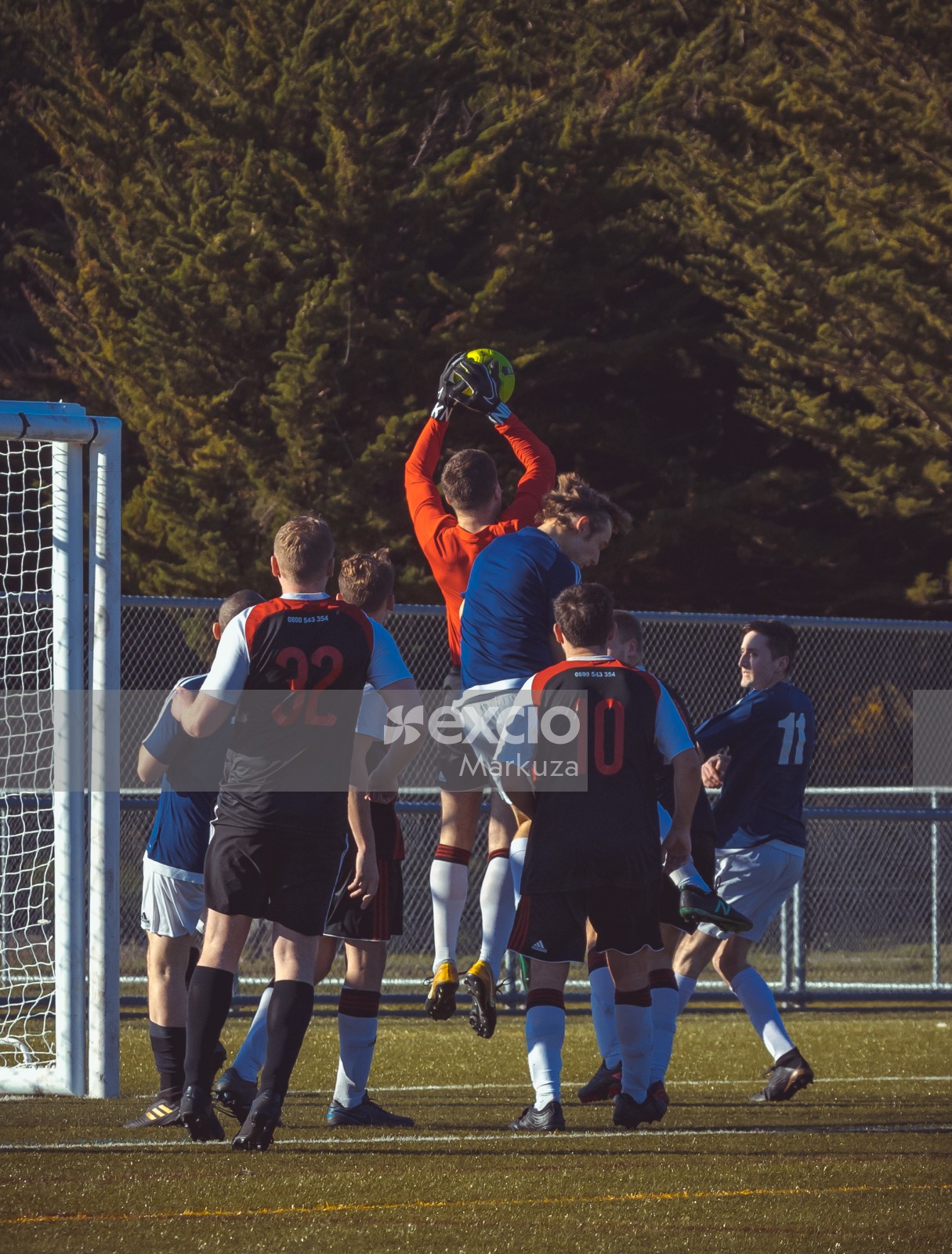 Goalkeeper catches neon yellow football midair - Sports Zone sunday league
