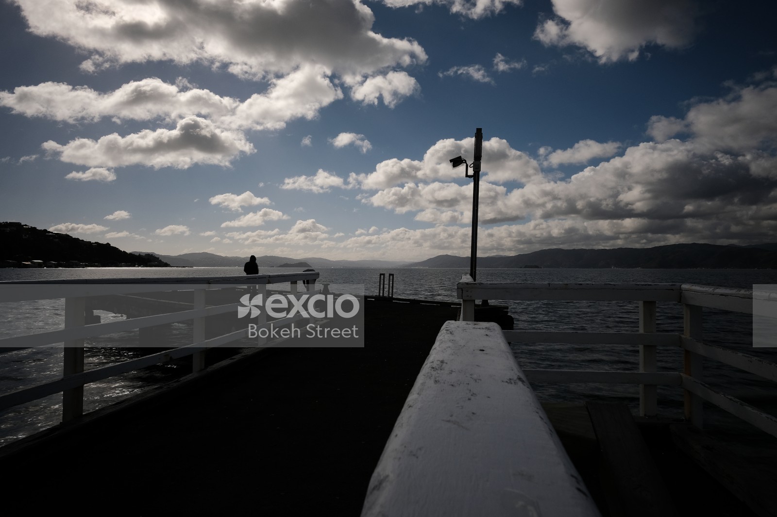 Pier silhouette and scattered clouds in Kilbirnie