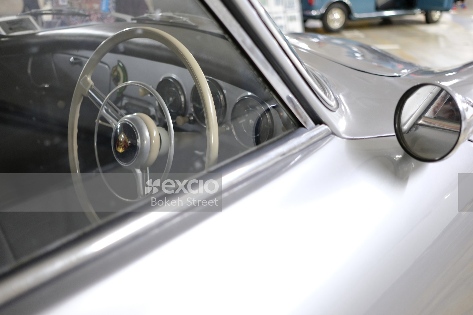 Classic silver Porsche steering wheel and side mirror