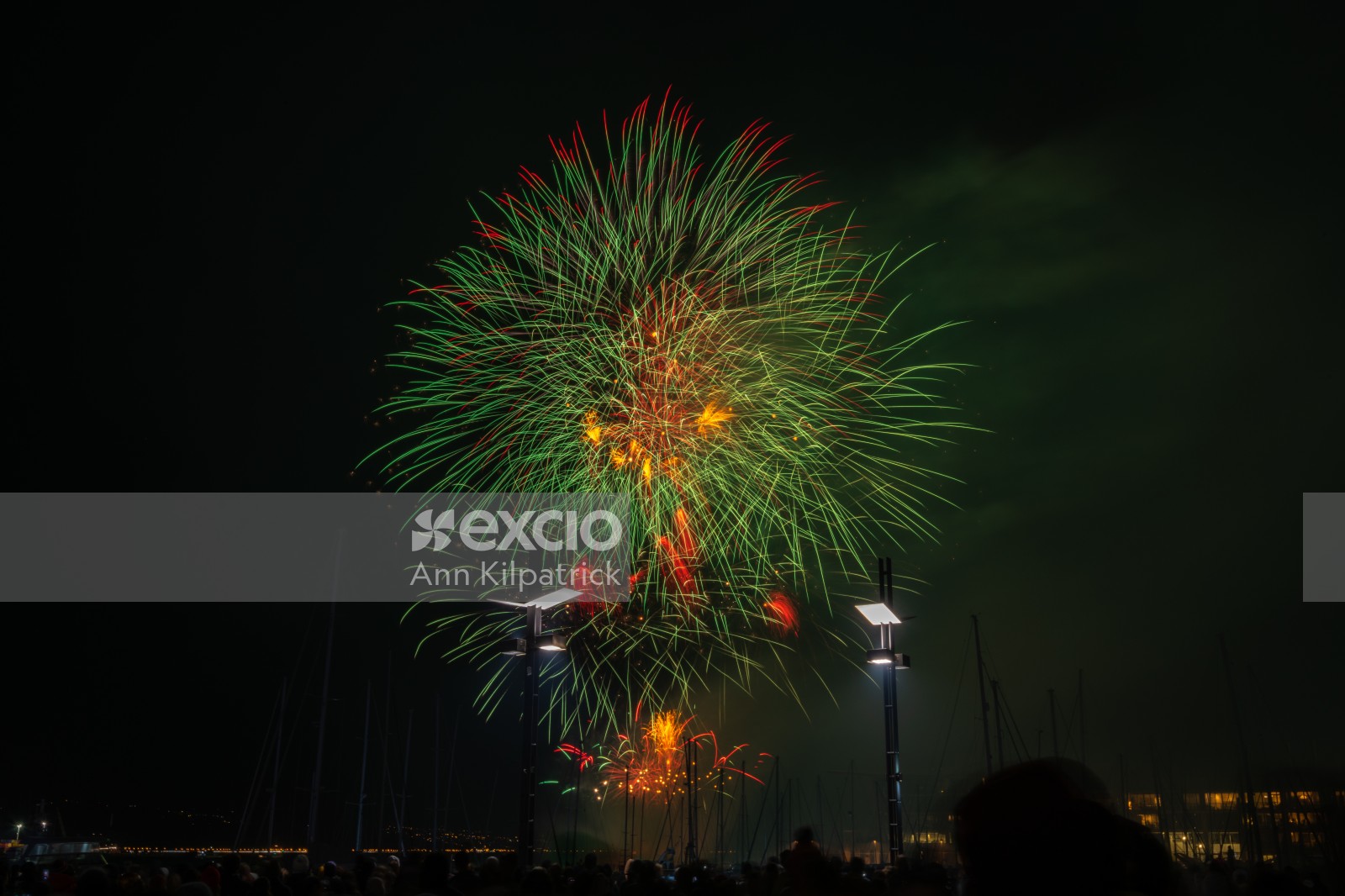 Green and orange fireworks over harbour