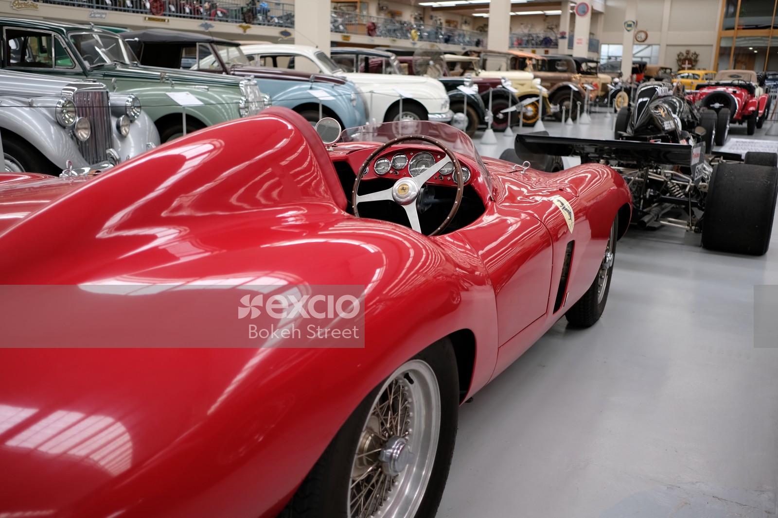 Red Ferrari classic race car at a museum