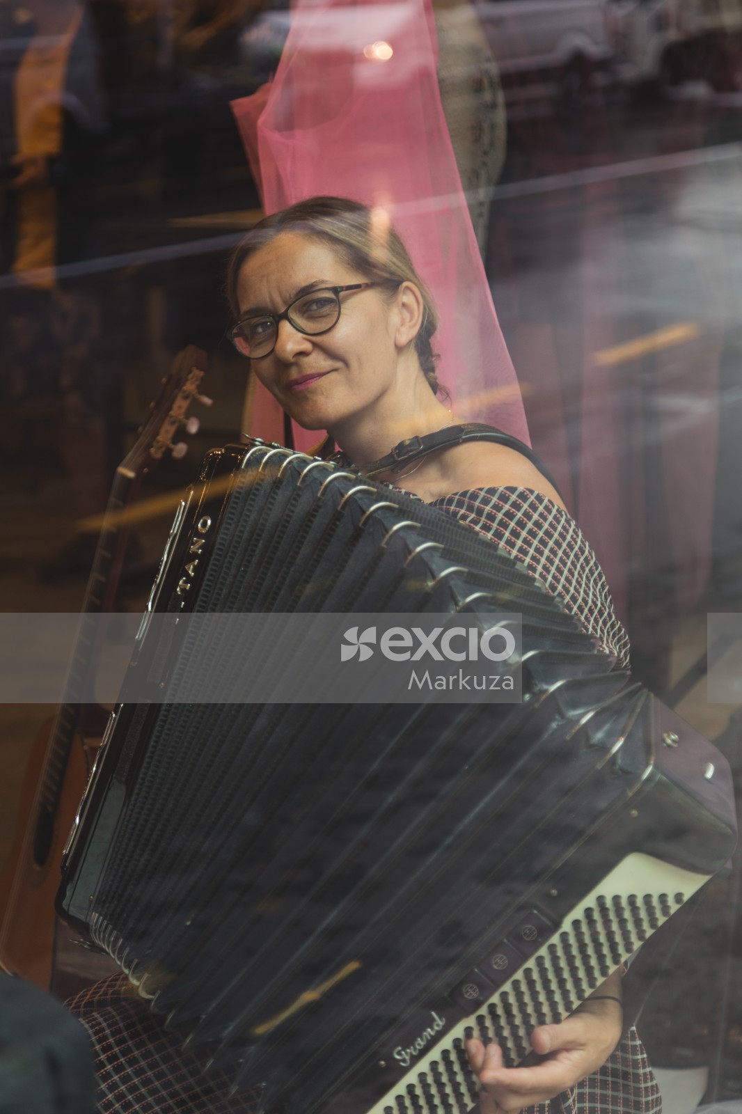 Woman in glasses playing accordion