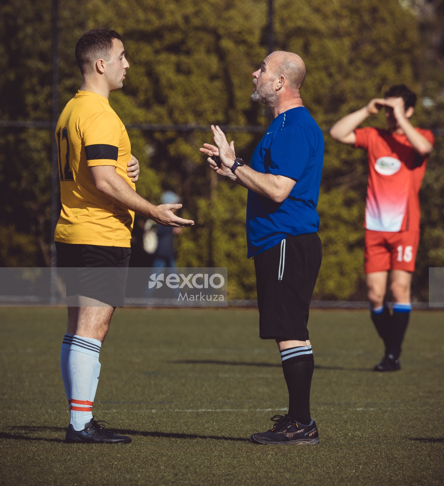 Referee talking to football player during match - Sports Zone sunday league