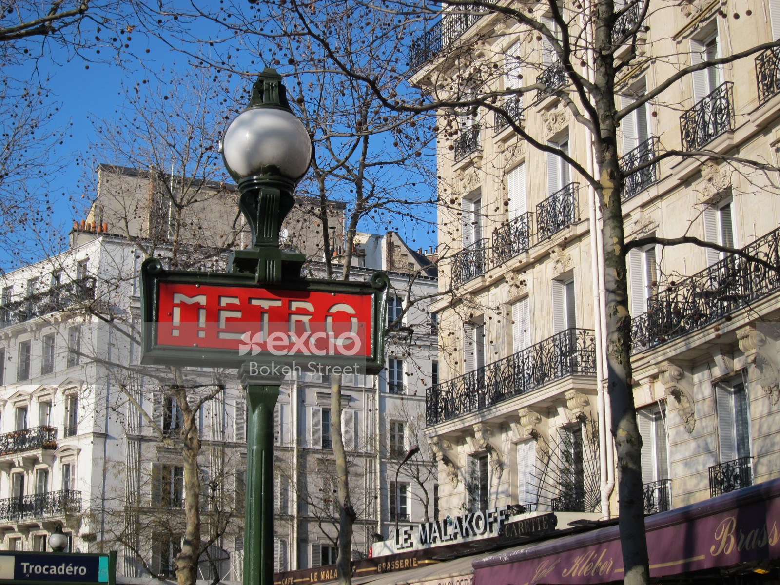 Street light and Paris metro signage in a street