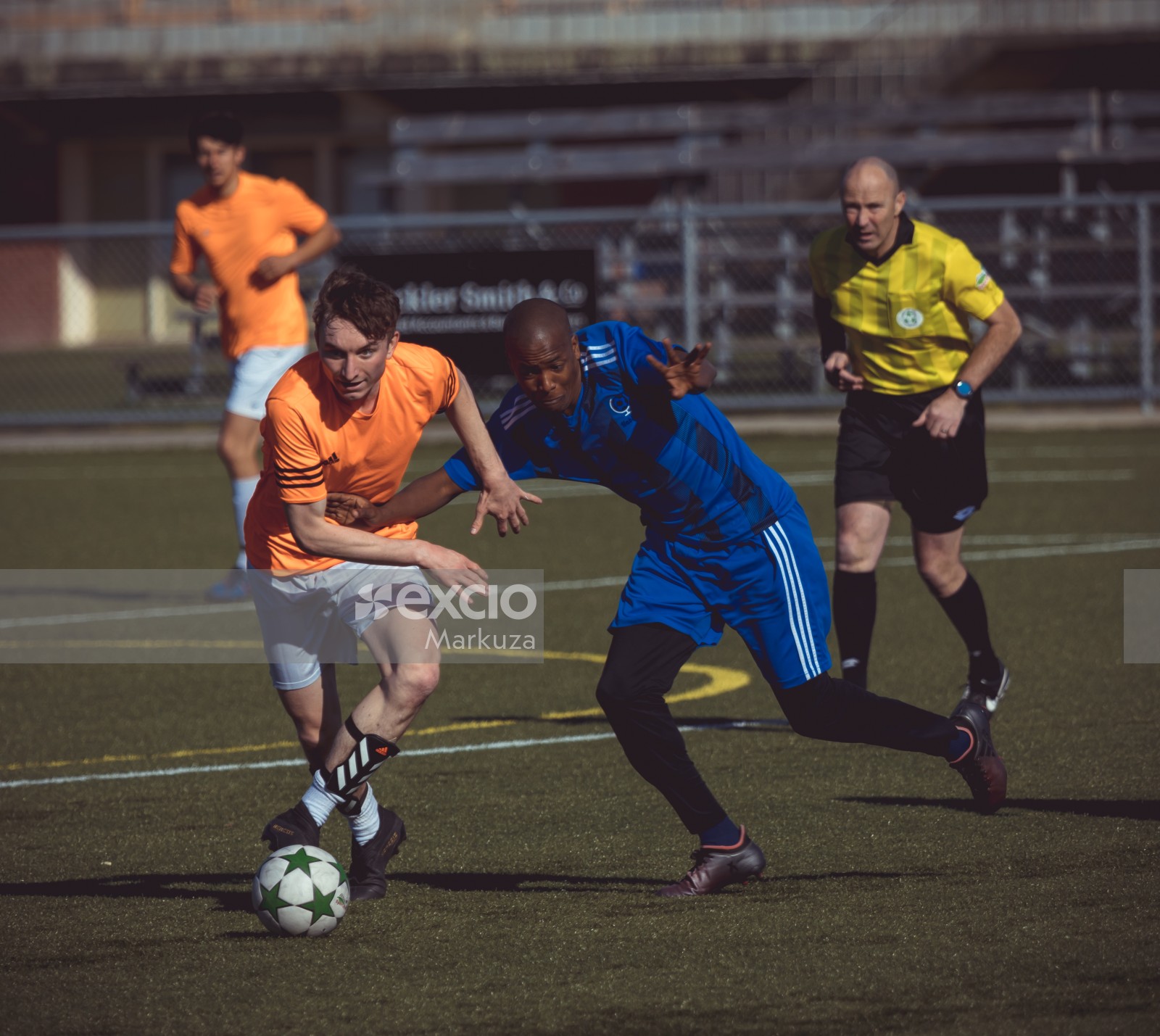 Habibis FC bald player trying to tackle opponent team's player - Sports Zone sunday league