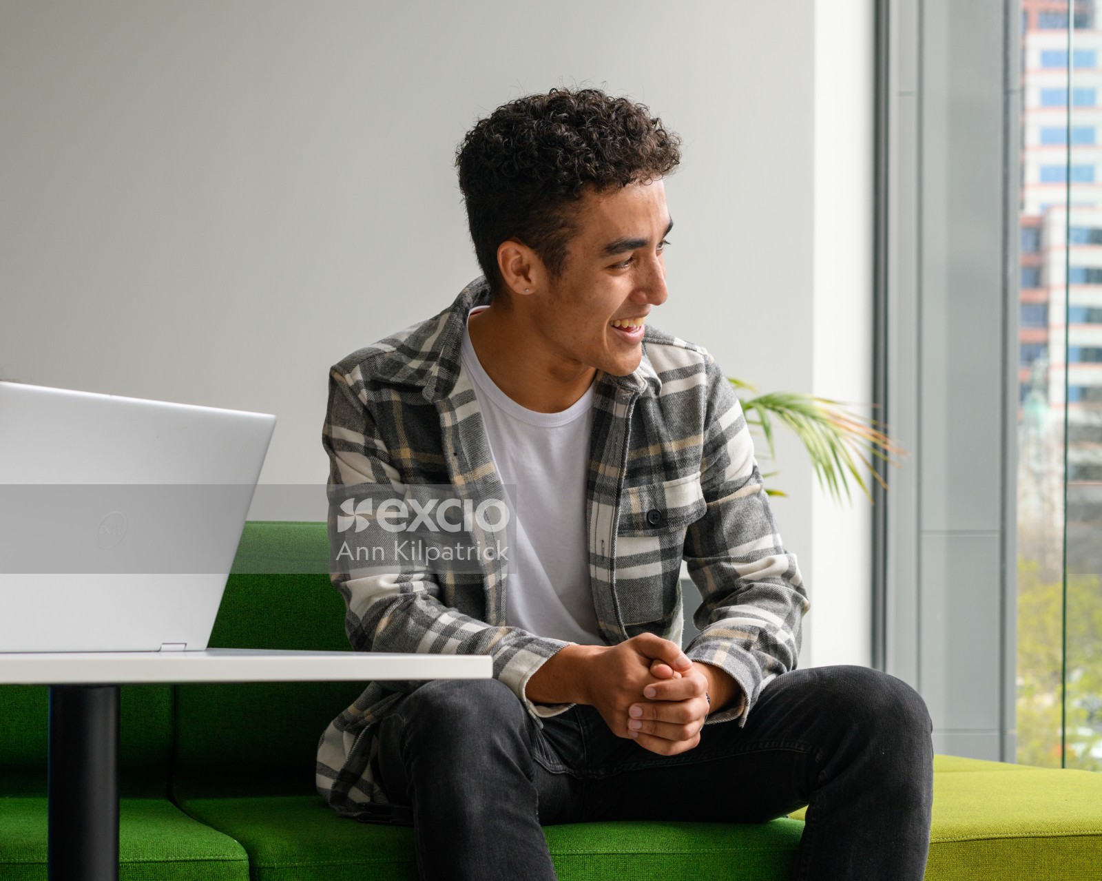 Young man looking out window in student space