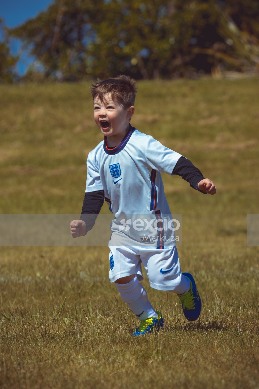 Boy wearing England kit running - Little Dribblers