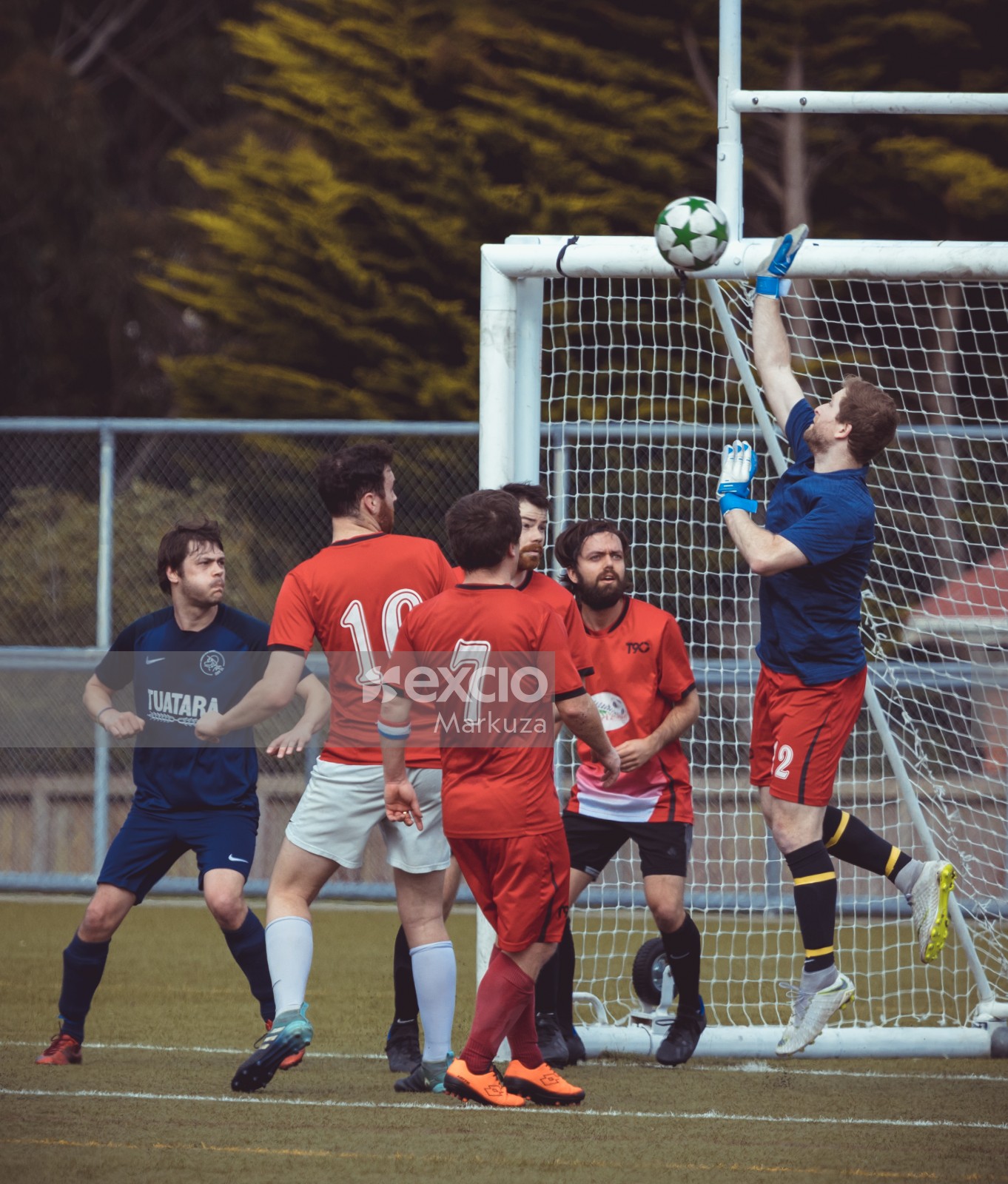 Goalkeeper slapping away ball from scoring a goal - Sports Zone sunday league