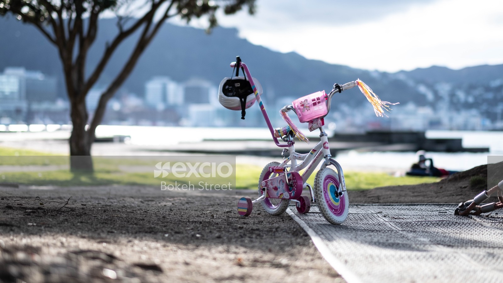 Cute little bicycle at the beach and city in the distance bokeh