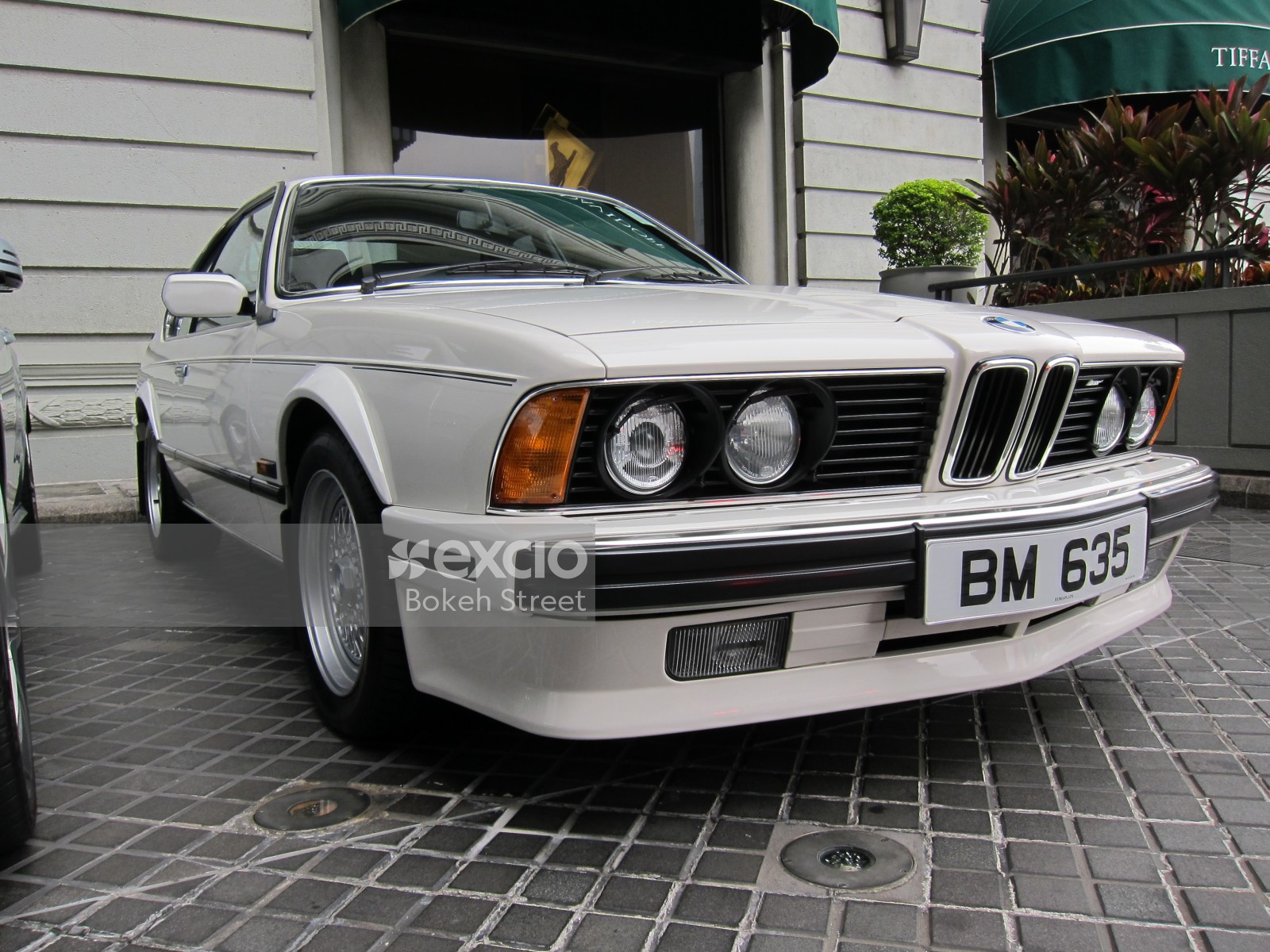 Classic white BMW 6 series outside a hotel in Hong Kong