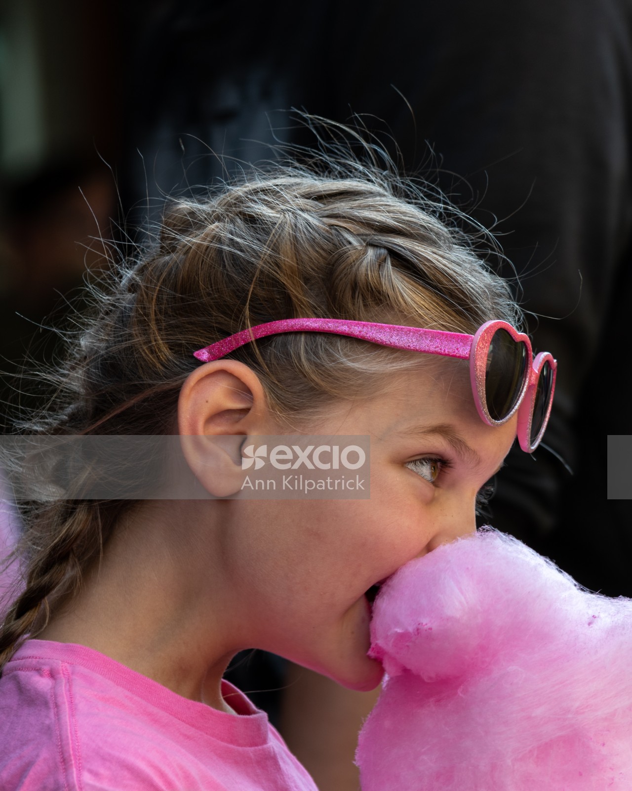 Young girl eating candy floss