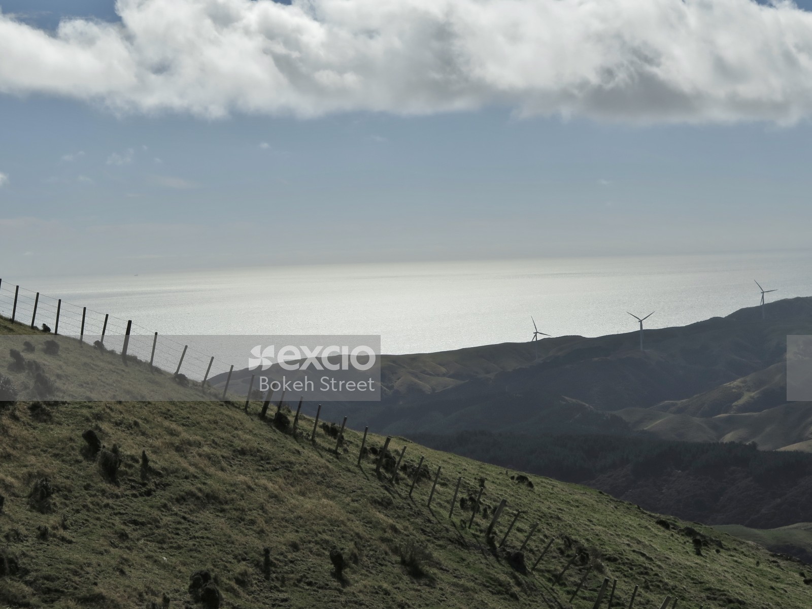 Fencing on grassy mountains and wind turbines Ohariu Wellington