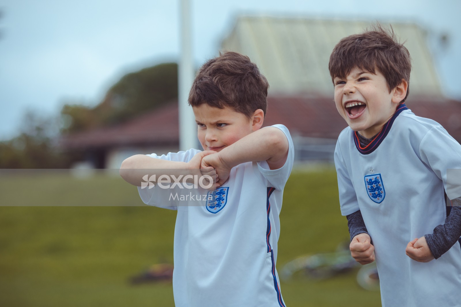 Boys in white shirts excited at Little Dribblers football match