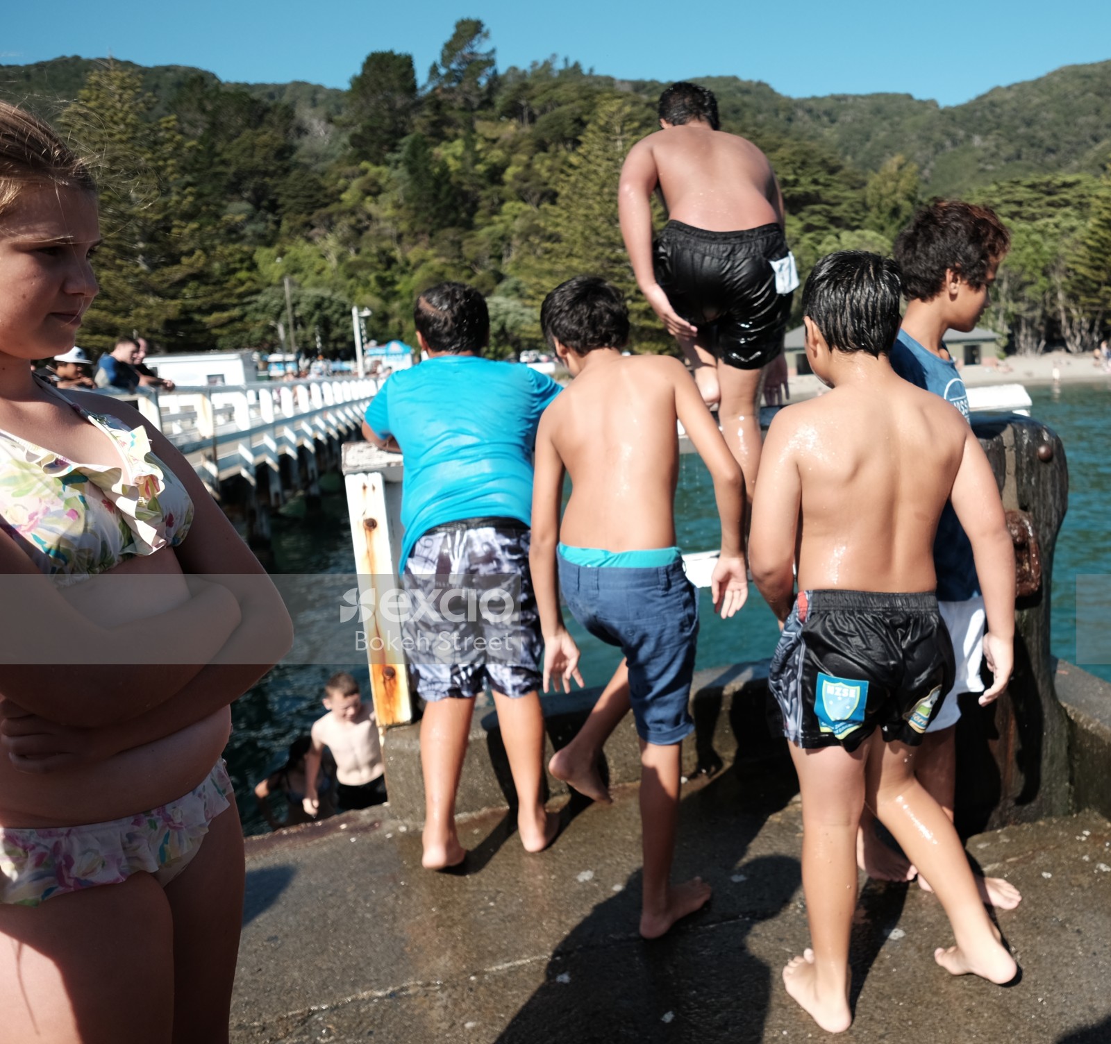 Kids waiting their turn to jump in the water at Days bay