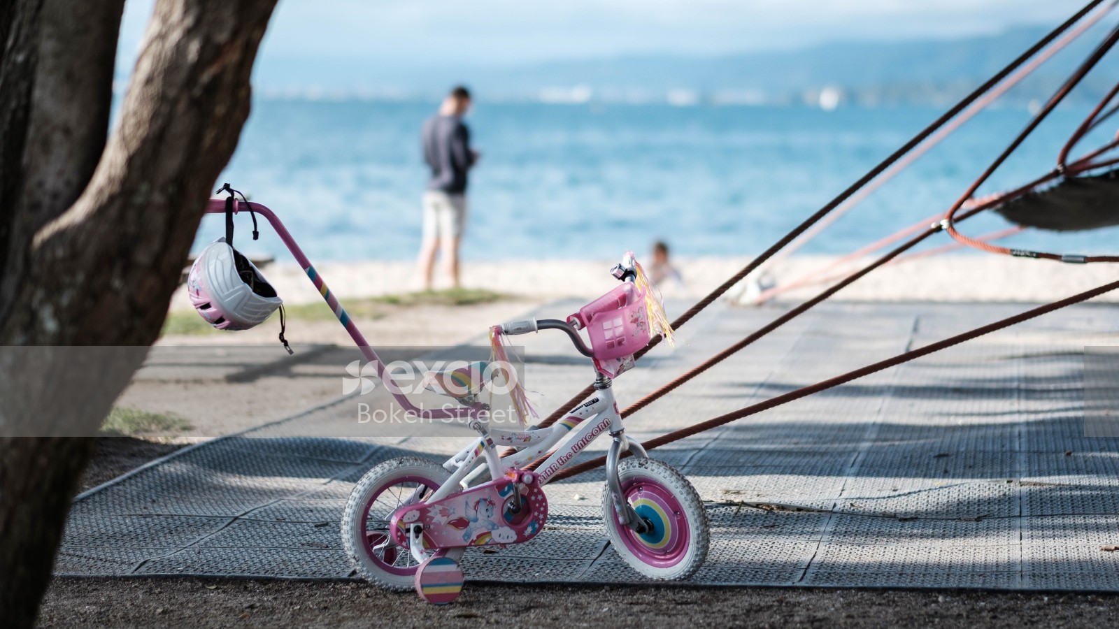 A little girl's bicycle and helmet at the beach
