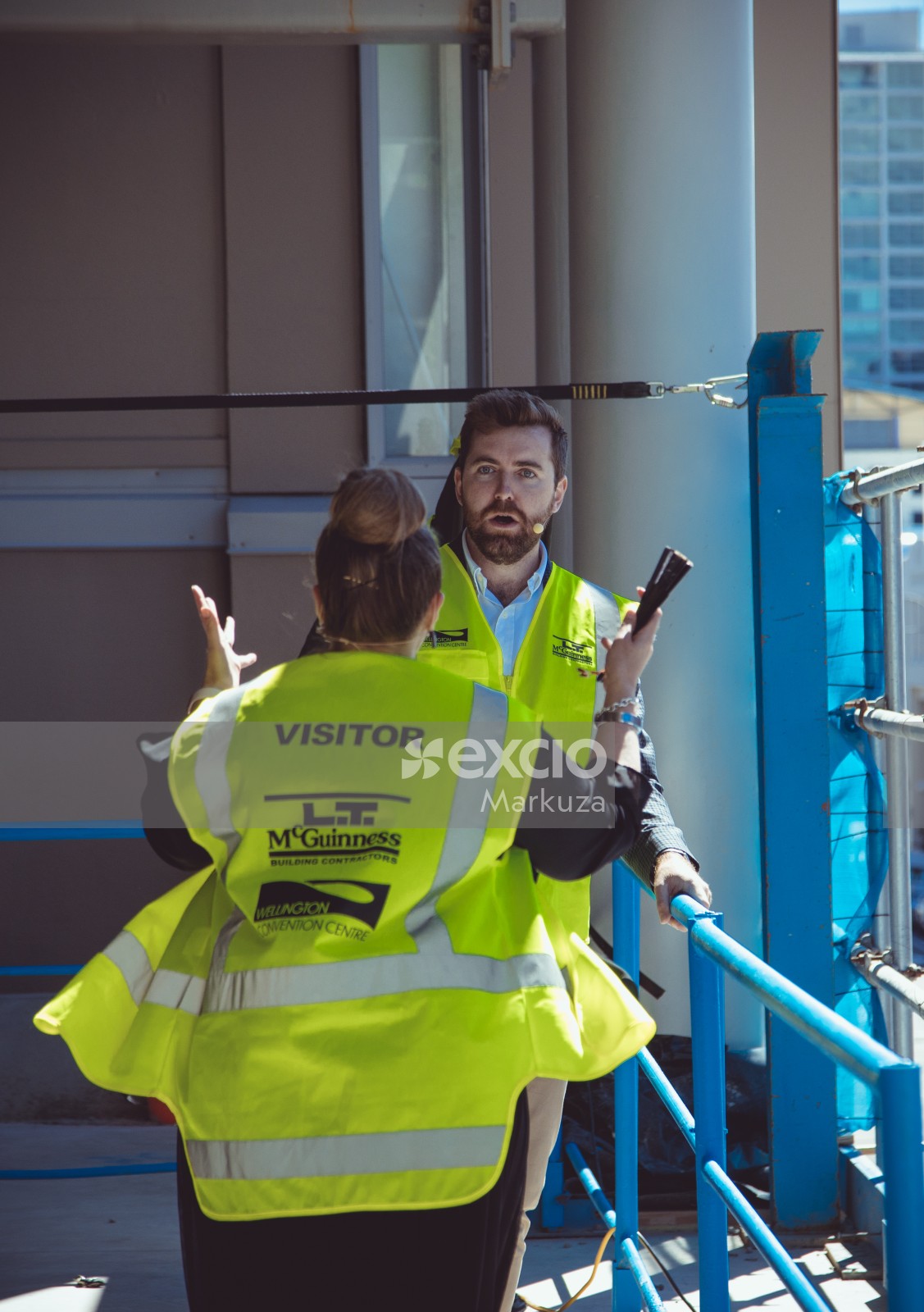 Woman yelling at man in high visibility vest