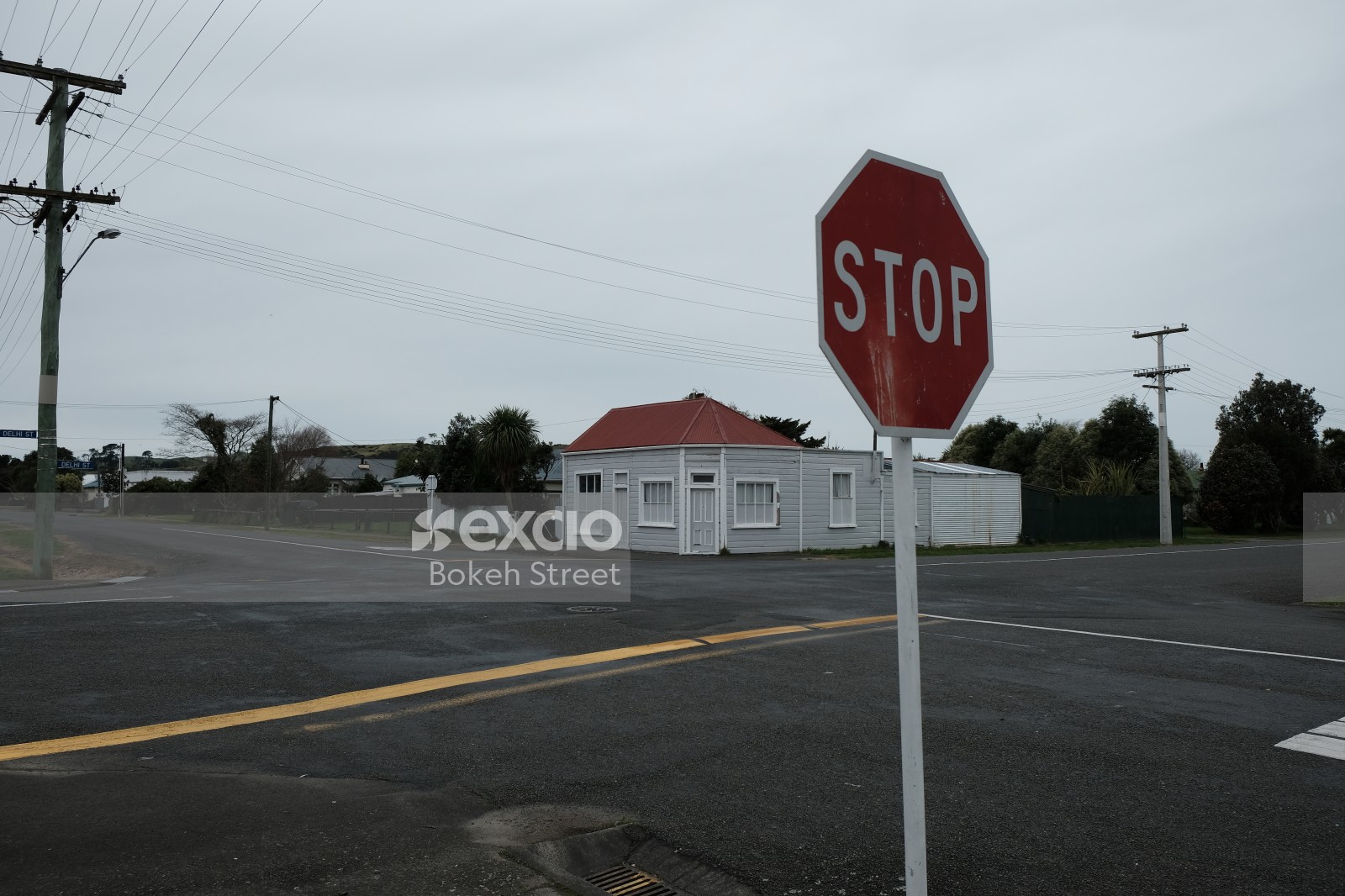 Stop sign at a fourway junction and corner building